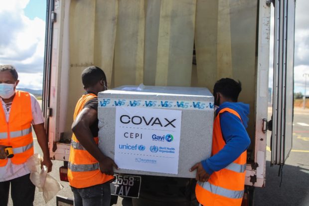 Workers load boxes of Oxford/AstraZeneca Covid-19 vaccines, part of the the Covax programme, which aims to ensure equitable access to Covid-19 vaccinations, into a truck after they arrived by plane at the Ivato International Airport in Antananarivo, Madagascar, on May 8, 2021. (Photo by Mamyrael / AFP)