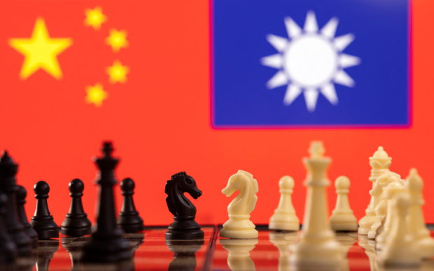 Chess pieces are seen in front of displayed China and Taiwan's flags in this illustration taken January 25, 2022. REUTERS/Dado Ruvic/Illustration