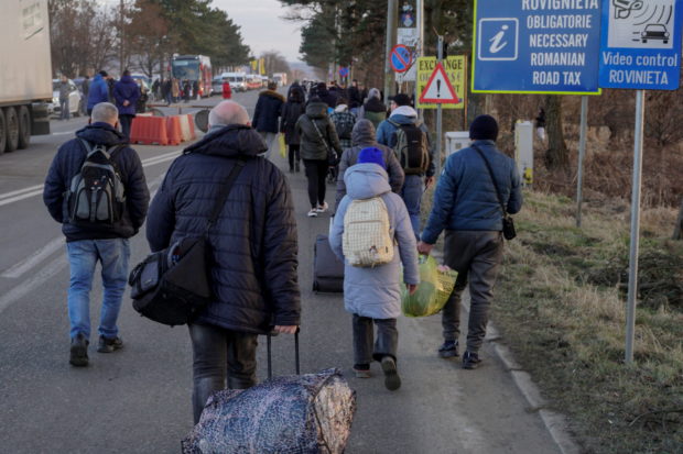 People cross the border from Ukraine into Romania at Siret Customs, in Suceava, Romania, February 24, 2022. Inquam Photos/Casian Mitu via REUTERS