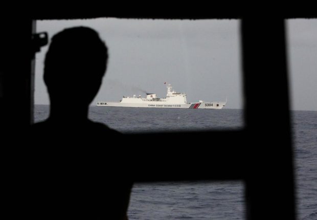 The China Coast Guard ship with bow No. 5304 shadows one of two Philippine Navy boats on a resupply mission to the BRP Sierra Madre at Ayungin Shoal in the West Philippine Sea on June 21, later radioing troops on the rusting warship that they face consequences if they “insist on making trouble.” (MARIANNE BERMUDEZ / Philippine Daily Inquirer)