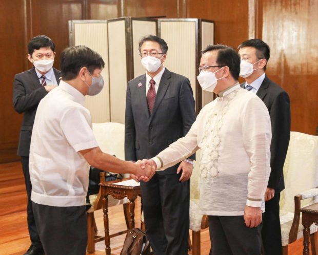 Ferdinand Marcos Jr. and Huang Xilian. STORY: Marcos will ask China envoy to explain remark on Taiwan OFWs