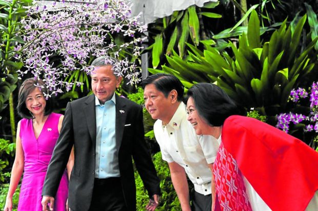 GARDEN GUESTS President Marcos, first lady Liza Araneta-Marcos, Singapore Foreign Minister Vivian Balakrishnan and his wife, Joy, attend an orchid naming ceremony at Singapore’s National Orchid Garden on Sept. 7. Mr. Marcos returned late Wednesday night from his first two state visits that began on Sept. 4 in Indonesia. —AFP