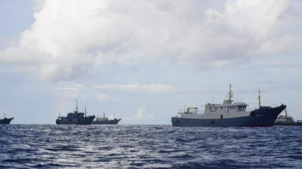 Several ships believed to be Chinese maritime militia were spotted by fishermen in Iroquois Reef in the West Philippine Sea in this photo taken in September. The military said an average of 25 vessels have been monitored there from September to December based on their patrols. CONTRIBUTED PHOTO
