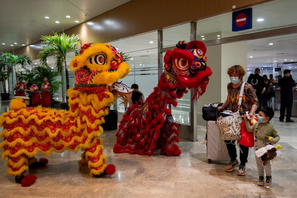 Dragon dance performers greet travelers from China at the Ninoy Aquino International Airport