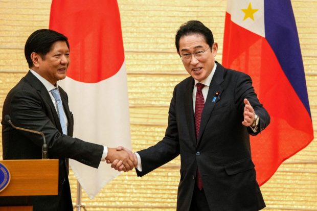 Japanese Prime Minister Fumio Kishida (R) shakes hands with Philippine President Ferdinand Marcos during a press conference at the prime minister's official residence in Tokyo on February 9, 2023. (Photo by Kimimasa MAYAMA / POOL / AFP)