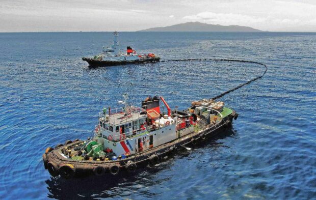 Together with an oil spill boom and skimmer, the Philippine Coast Guard (PCG) is seen circling around the suspected area of the sunken oil tanker MT Princess Empress at the northeast of Balingawan Port, Lucta Port, and Buloc Bay in Oriental Mindoro on March 14, 2023. | PHOTO: Malayan Towage and Salvage Corporation via Philippine Coast Guard