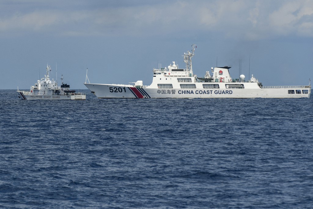This photo taken on April 23, 2023 shows the Philippine coast guard vessel BRP Malapascua (L) manoeuvering as a Chinese coast guard ship cuts its path at Second Thomas Shoal in the Spratly Islands in the disputed South China Sea. AFP file photo