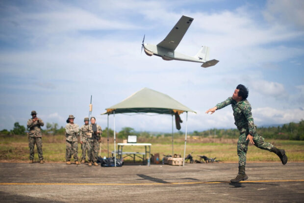 Philippine Marine with Force Reconnaissance Group, Small Unmanned Aircraft System Team 1, launches a RQ-20B Puma AE small unmanned aircraft system during Balikatan 23 at Cagayan Airfield, Philippines, April 13, 2023. (U.S. Marine Corps photo by Cpl. Eric Huynh)