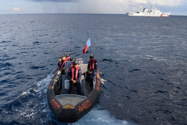 In this file photo taken on April 23, 2023, personnel of the Philippine Coast Guard ship BRP Malabrigo prepare to conduct a survey in the waters of Second Thomas shoal in the Spratly Islands in the disputed South China Sea. STORY: PH, US looking forward to trilateral pacts with Japan, Australia