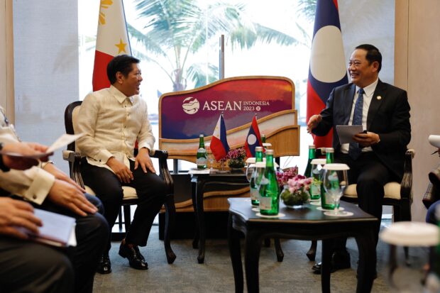 Philippines President Ferdinand "Bongbong" Marcos Jr. and Laos Prime Minister Sonexay Siphandone talk during a bilateral meeting on the sidelines of the Association of Southeast Asian Nations (ASEAN) Summit held in Labuan Bajo on May 10, 2023. (Photo by WILLY KURNIAWAN / POOL / AFP)