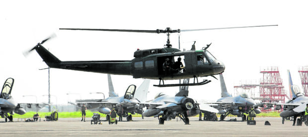 PREFLIGHT PREPS American F-16 fighter jets, with a military chopper in the foreground, await orders to take off at Clark Air Base in Pampanga on Tuesday in connection with the revived “Cope Thunder” exercises between US and Philippine air forces. Being held this month and again in July, the drills will involve around 160 American and 400 Filipino servicemen. —NIÑO JESUS ORBETA