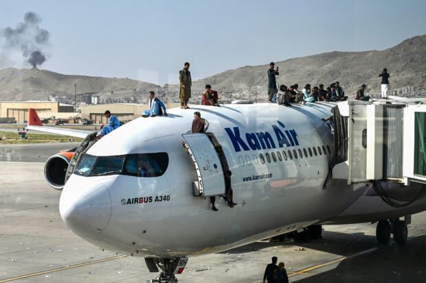 LAST PLANE OUT Men clamber on top of one of the last planesto fly out of Afghanistan after the fall of the capital, Kabul, to the Taliban on Aug. 16, 2021. —AFP IMEE MARCOS AFGHAN REFUGEES