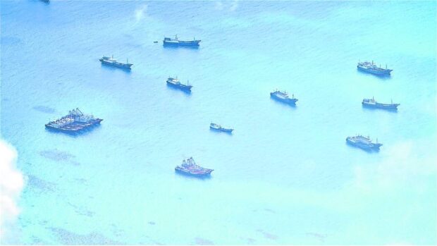 WHERE’S THE FISH? A cluster of Chinese vessels is seen atDel Pilar (Iroquois) Reef on June 30. Pilots who took this photo noted that while they appeared to be fishing boats, they just lingered in the area and hardly engaged in any fishing activity. —AFP WESCOMPHOTO