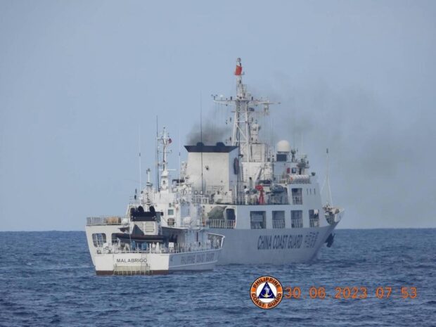 TOO CLOSE FOR COMFORT. A China Coast Guard ship gets “dangerously close”— as the Philippine Coast Guard puts it— to a much smaller PCG vessel in the waters near Ayungin (Second Thomas) Shoal in the West Philippine Sea, in this photo taken on June 30. (PCG)