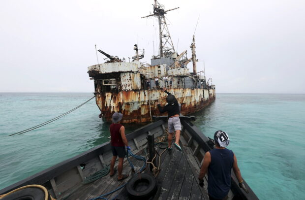 Members of a resupply mission approach the grounded BRP Sierra Madre at Ayungin (Second Thomas) Shoal, one of the nine outposts guarding the West Philippine Sea, to replenish supplies for its troops. 