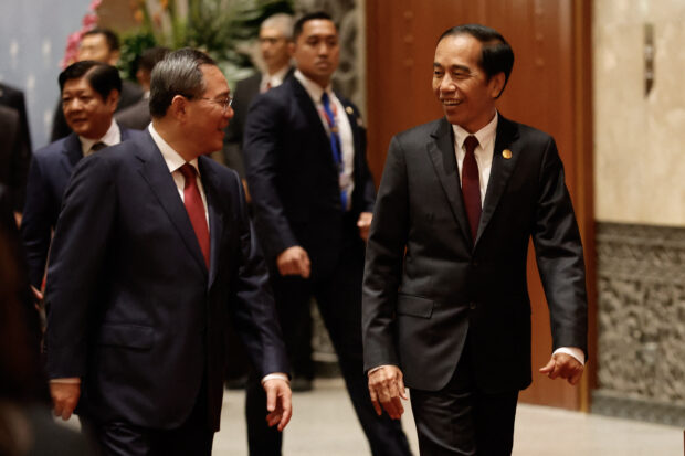 Chinese Premier Li Qiang and Indonesian President Joko Widodo arrive for a family photo before the ASEAN-China Summit in Jakarta on Sept. 6, 2023.