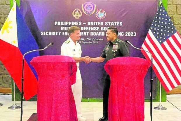 SHAKE ON IT US Indo-Pacific Command chief Adm. John Aquilino and Armed Forces of the Philippines Chief of Staff Gen. Romeo Brawner Jr. announce an agreement to seek additional sites to host American troops and equipment on Thursday. Out of the current nine sites, four were granted by the Marcos administration.