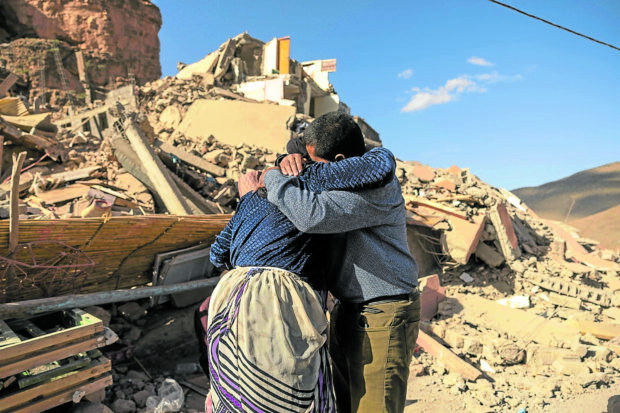 TRAGEDY Family members console each other near the rubble of collapsed buildings in the village of Imi N’Tala near Amizmiz in central Morocco after a deadly magnitude 6.8 earthquake hit the country last week. —AFP