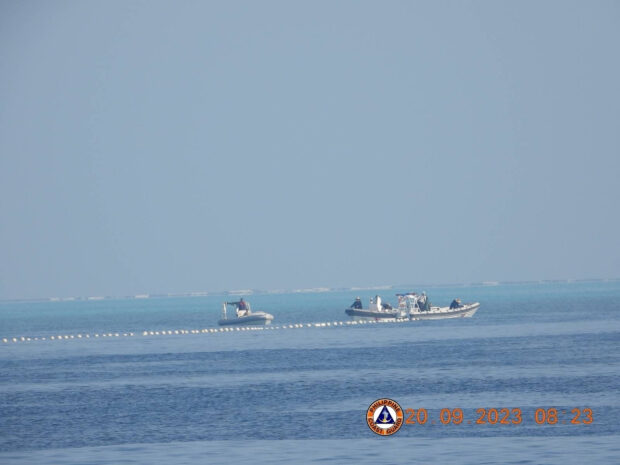Chinese Coast Guard boats close to the floating barrier are pictured near the Scarborough Shoal