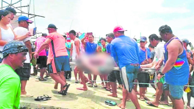 Thebodies of the three victims are brought to shore on Tuesday in Infanta, Pangasinan. —PCG PHOTO