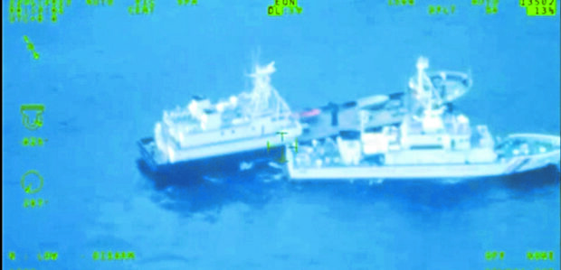 HARASSMENT AT SEA A China Coast Guard vessel (right) blocks a Philippine boat carrying supplies for military troops on BRP Sierra Madre.