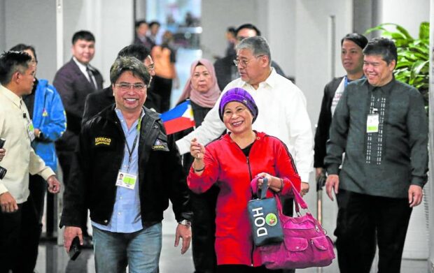 HOME, FINALLY Filipino repatriates from the Gaza StripIsabelita Balala (holding flag), 62, and Minerva Sabah, 58, (behind her), are welcomed by officials of the Department of Foreign Affairs and the Overseas Workers Welfare Administration at Ninoy Aquino International Airport on Friday. They are among the latest batch of 34 Filipinoswho arrived in the country after the Rafah border was opened recently. —LYN RILLON