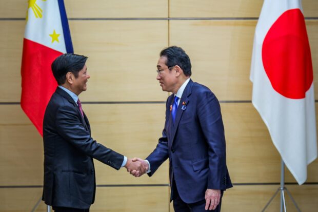 SEALED President Marcos and Japanese Prime Minister Fumio Kishida shake hands after witnessing the exchange of memorandum of cooperation between the Philippines and Japan on Sunday. —MALACA΍ANG PHOTO