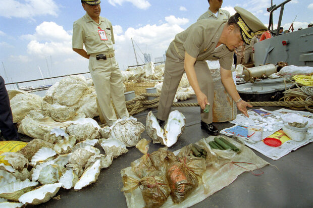 Philippine Navy officials inspect giantclams, several pieces of dynamite and some cyanide seized from Chinese fishermen apprehended at Panatag (Scarborough) Shoal, in this March 2001 Inquirer file photo. 