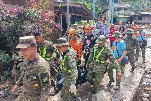 In this handout photo from the Eastern Mindanao Command, Armed Forces of the Philippines (AFP) taken on February 7, 2024 and received on February 8, 2024, shows responders conduct search and rescue operations in Maco, Davao de Oro. At least 11 people were injured when a rain-induced landslide buried two buses picking up workers from a gold mine in the southern Philippines, officials said. Rescuers used their bare hands and shovels to dig through mud on February 8 in a desperate search for survivors of a landslide in the Philippines as the death toll rose to 10, officials said. (Photo by Handout / Armed Forces of the Philippines' Eastern Mindanao Command / AFP) / RESTRICTED TO EDITORIAL USE - MANDATORY CREDIT "AFP PHOTO / Armed Forces of the Philippines' Eastern Mindanao Command" - NO MARKETING NO ADVERTISING CAMPAIGNS - DISTRIBUTED AS A SERVICE TO CLIENTS