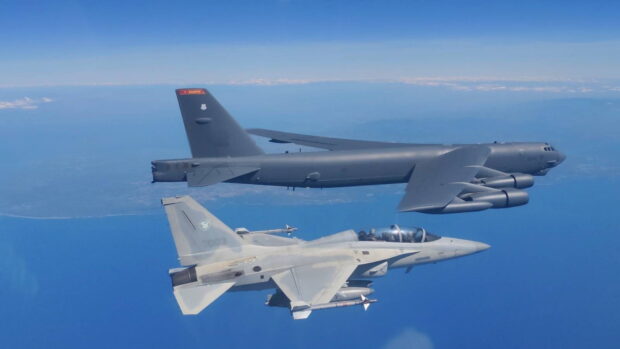 WHILE CHINA KEEPSWATCH An FA-50 combat aircraft of the Philippine Air Force (PAF) flies alongside the B-52H bomber sent by the United States Pacific Air Forces to its joint patrol with the PAF over the West Philippine Sea on Feb. 19. —PHOTO FROMPAF