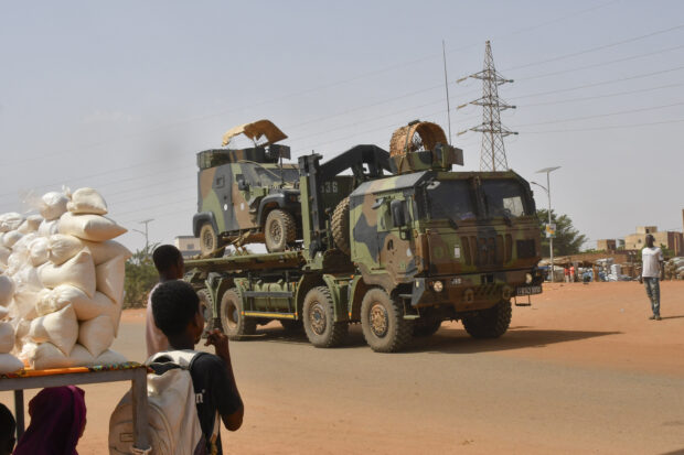 A French Army military vehicle belonging to a convoy of French troops is seen crossing the Lazaret district in Niamey on October 10, 2023. A new page has been turned for France with the departure of the first French soldiers from Niger in a ground convoy under local escort, from the west of the country to a destination that could be Chad, according to several security sources. The withdrawal of the French troops had been demanded by Niger's generals shortly after they came to power in a coup at the end of July, and French President Emmanuel Macron announced their departure at the end of September. (Photo by AFP)