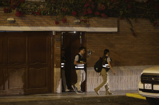 Police leave President Dina Boluarte's house during a raid ordered by the Attorney General's Office as part of a preliminary investigation in Lima on March 30, 2024. Peruvian authorities raided President Dina Boluarte's home on March 30 as part of an ongoing corruption investigation related to undisclosed luxury watches.