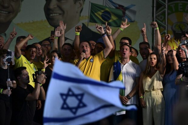 Brazil's former President Jair Bolsonaro (C) sings next to Alexandre Ramagem (4th-R) 