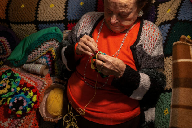 A 93-year-old Greek grandmother knits scarves for children in need.