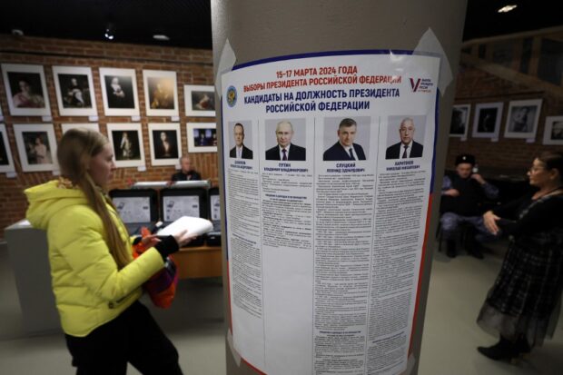An information poster with images and biographies of the four candidates, including Russian President Vladimir Putin