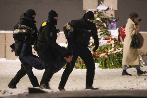 Police officers detain a man laying flowers to Alexei Navalny at the Memorial to Victims of Political Repression in St. Petersburg, Russia on Friday, Feb. 16, 2024. Russian authorities say that Alexei Navalny, the fiercest foe of President Vladimir Putin, died in prison. He was 47. (AP Photo, File)