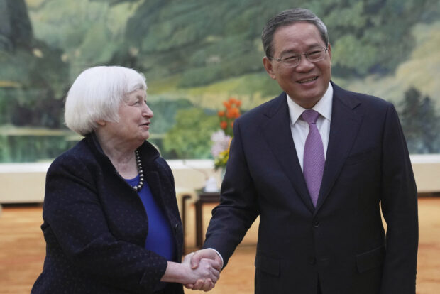US Treasury Secretary Janet Yellen (L) shakes hands with Chinese Premier Li Qiang at the Great Hall of the People in Beijing on April 7, 2024. US Treasury Secretary Janet Yellen and Chinese Premier Li Qiang sounded a hopeful note on bilateral relations at the start of their April 7 meeting in Beijing, as Yellen begins two days of high-level talks in Beijing.Tatan Syuflana / POOL / AFP
