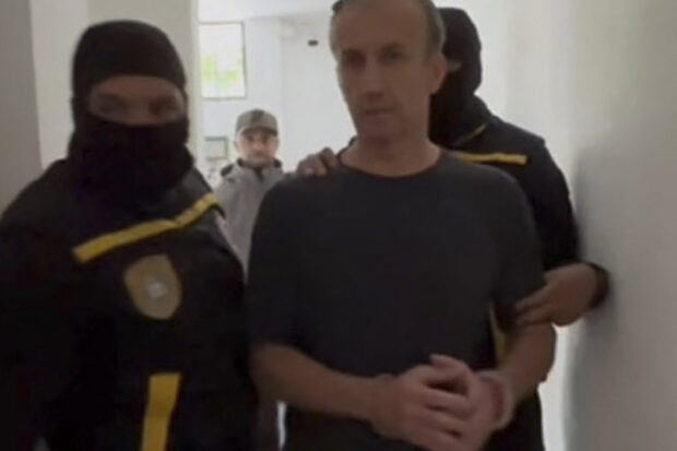 This handout pictured released by the Venezuelan Public Prosecutor's Office on April 9, 2024, shows former Venezuelan oil minister Tareck El Aissami (R) being detained by members of the National Anti-Corruption Police. Venezuelan authorities announced on April 9, 2024, the arrest of influential ex-oil minister Tareck El Aissami, who had resigned from his post last year amid a corruption scandal at state oil company PDVSA. (Photo by Handout / Venezuelan Public Prosecutor's Office / AFP) / RESTRICTED TO EDITORIAL USE - MANDATORY CREDIT "AFP PHOTO / VENEZUELAN PUBLIC PROSECUTOR'S OFFICE" - NO MARKETING NO ADVERTISING CAMPAIGNS - DISTRIBUTED AS A SERVICE TO CLIENTS