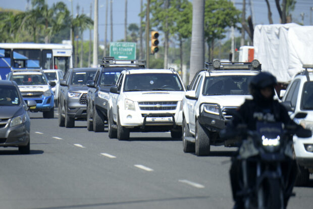 The caravan of vehicles transporting Ecuador's ex-vice president Jorge Glas from the Naval Hospital to the maximum security prison La Roca is seen in Guayaquil, Ecuador, on April 9, 2024. Former Ecuadorian vice president Jorge Glas, who was hospitalized, returned Tuesday to a maximum security prison, where he had been transferred on Saturday after his capture during a police raid on the Mexican embassy, according to the prison service (SNAI). (Photo by Gerardo MENOSCAL / AFP)