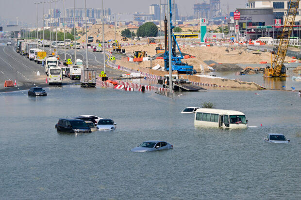 Cars are stranded on a flooded street in Dubai following heavy rains on April 18, 2024. Dubai's giant highways were clogged by flooding and its major airport was in chaos as the Middle East financial centre remained gridlocked on April 18, a day after the heaviest rains on record. 