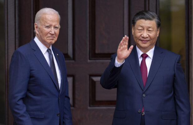 President Joe Biden, left, greets China's President President Xi Jinping in Woodside, Calif., Nov, 15, 2023. 