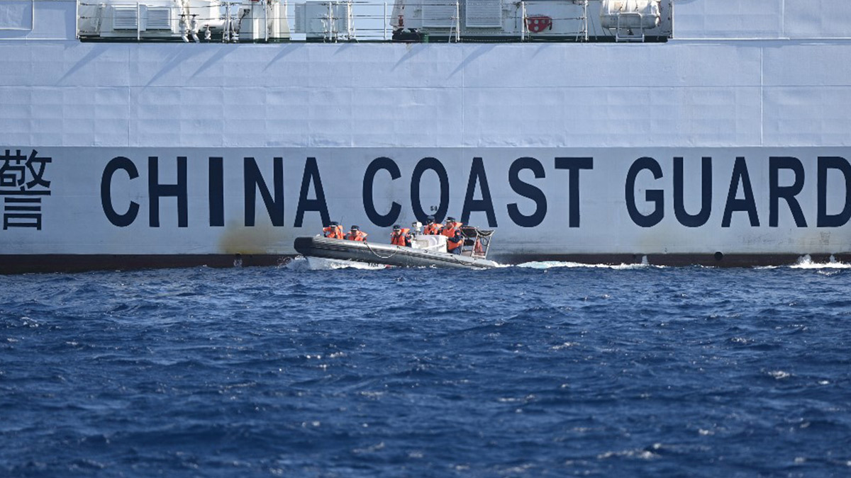 This photo taken on February 16, 2024 shows a rigid hull inflatable boat leaving a Chinese coast guard vessel near the China-controlled Scarborough Shoal, in disputed waters of the South China Sea. The Philippines on February 17 accused Chinese coast guard vessels of "dangerous" manoeuvres for attempting to block a Filipino vessel dropping supplies to fishermen at a reef off the Southeast Asian nation's coast. (Photo by Ted ALJIBE / AFP) china mutual defense us