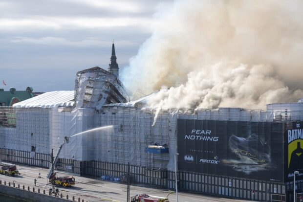 Massive fire topples spire at Copenhagen's historic stock exchange