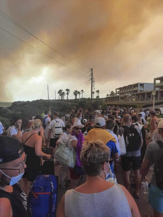 Tourists are evacuated from hotels during a wildfire on the Greek island of Rhodes