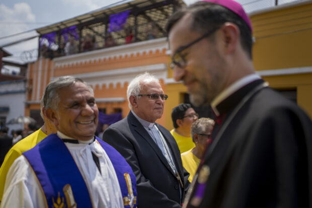 Cardinal Alvaro Ramazzini, center back, waits for the start of a religious procession, in Guatemala City