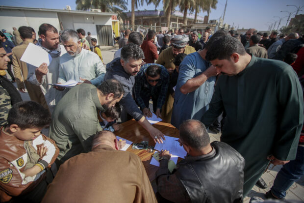 Supporters of the Shiite cleric Muqtada al-Sadr sign a pledge to stand against homosexuality or LGBTQ