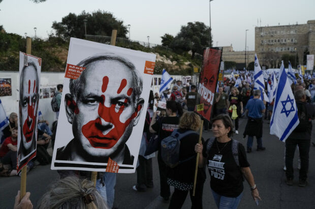 People take part in a protest against Israeli Prime Minister Benjamin Netanyahu's government