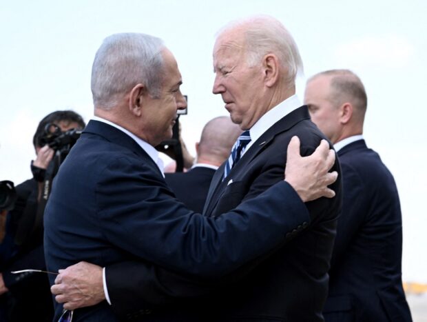 (FILES) Israel Prime Minister Benjamin Netanyahu (L) greets US President Joe Biden upon his arrival at Tel Aviv's Ben Gurion airport on October 18, 2023,