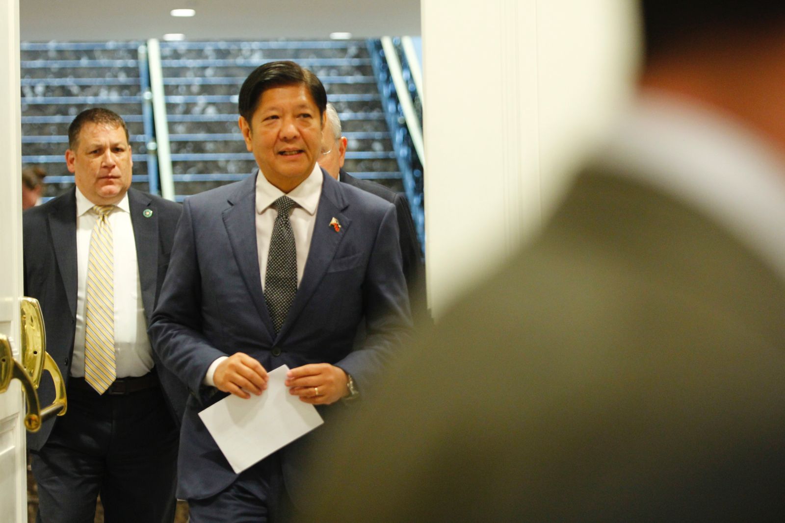 President Ferdinand Marcos Jr. walks toward a room in a Washington D. C. hotel, for a press briefing with members of the Philippine media delegation on April 12, 2024. Marcos addressed questions about the alleged gentleman’s agreement between China and former president Rodrigo Duterte, which he called a secret deal, during the press conference. Gabriel P. Lalu/ INQUIRER.net investment trilateral