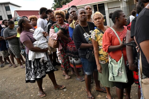 Solomon Islanders queue up to vote outside a polling station in Honiara on April 17, 2024. 